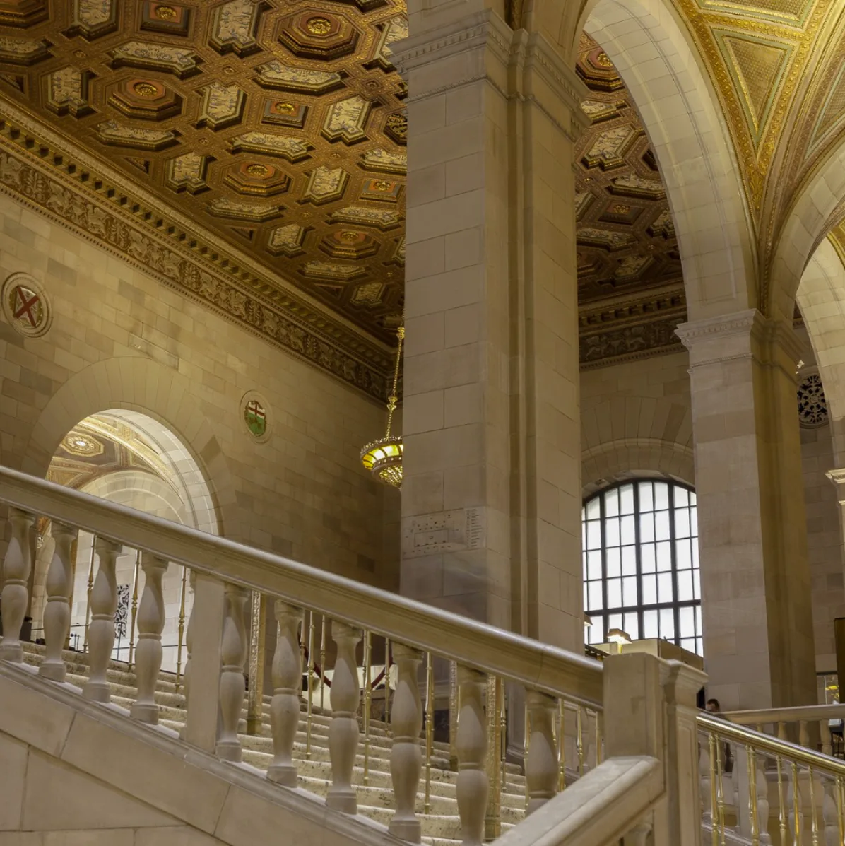Marble grand staircase beneath the gilded ceiling